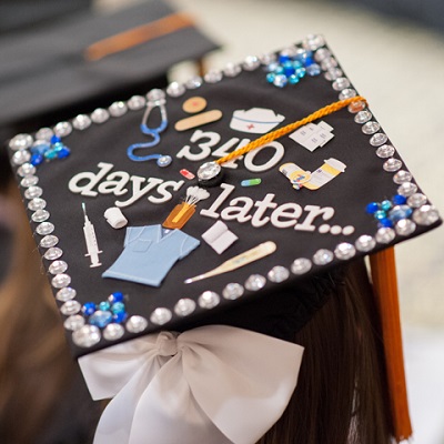 Students decorated grad cap that says 340 days later with nursing pictures