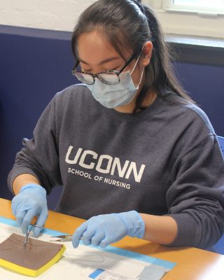 Nursing student working in lab.